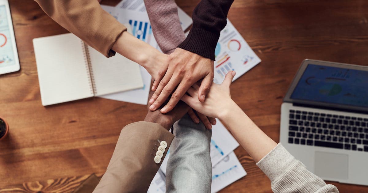Happy team collaborating to reduce employee turnover